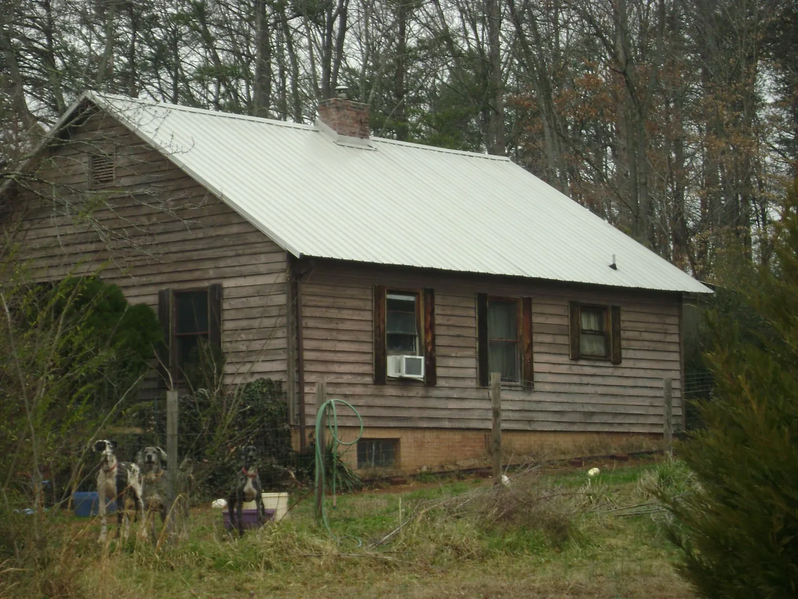 White metal roof on an old wood sided farmhouse, from a Metal Roof Installation job in East Brookfield